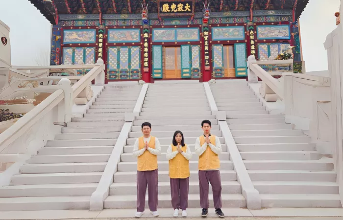 An international student in South Korea in front of a Buddhist temple